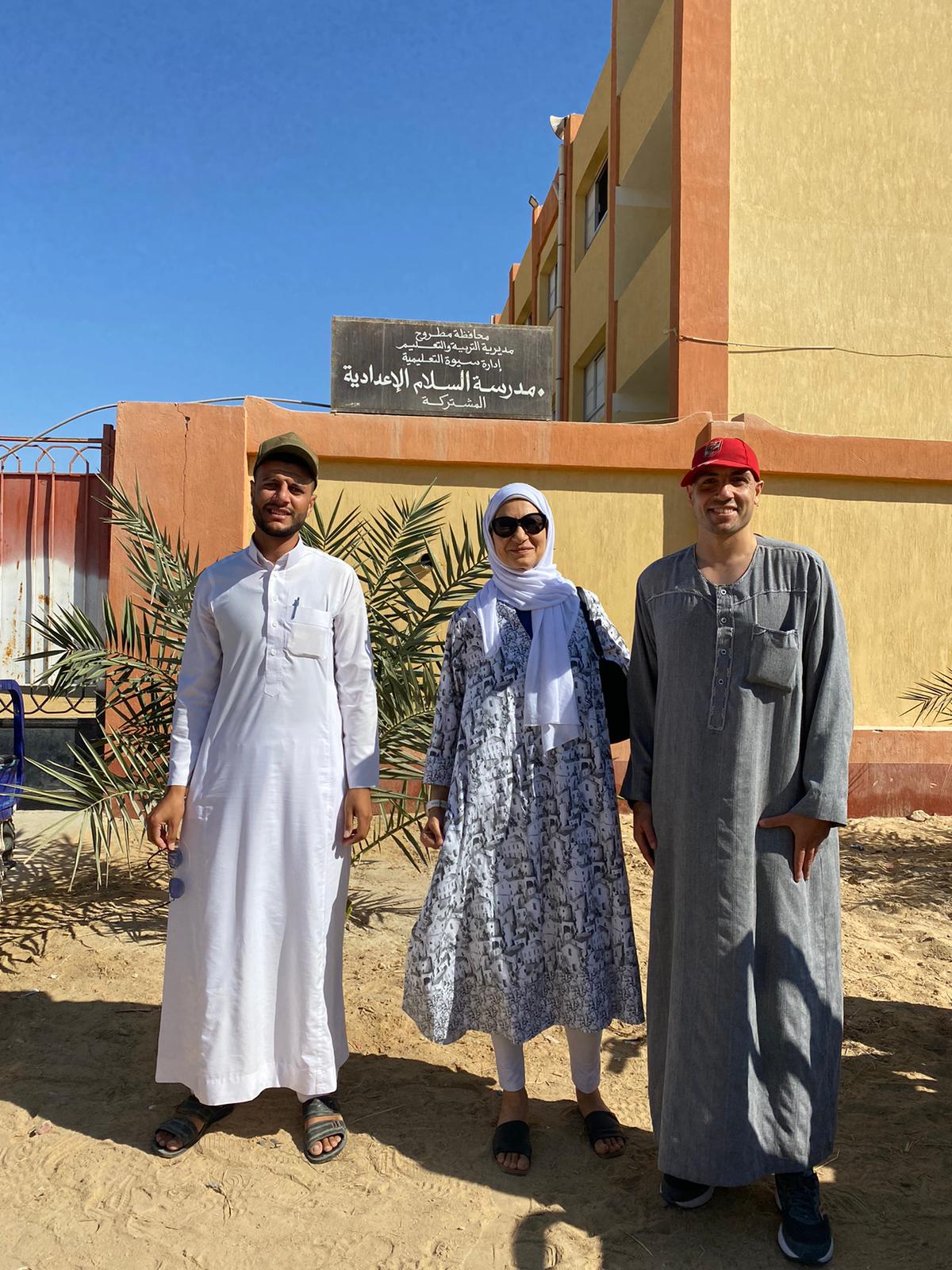Nehal, Omar and Nehal outside of an elementary school in Siwa in October 2024